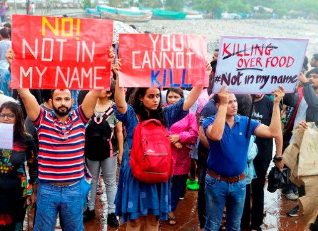 Protestors hold placards in Mumbai. PIC/AP.