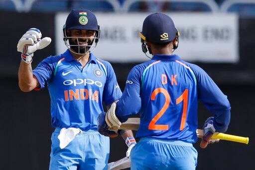 India's captain Virat Kohli, left, greets Dinesh Karthik after he scored half a century against West Indies during the fifth ODI at the Sabina Park cricket ground in Kingston, Jamaica, Thursday, July 6, 2017. India won the match by 8 wickets and the series 3-1.(AP Photo/Ricardo Mazalan)