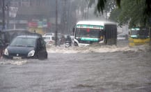 Ambulance with four family members washed away by flood waters