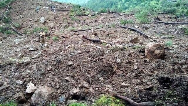 The landslide swept away the road and the buses for almost 800 metres down into a gorge. (Photo: AFP)