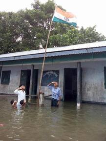 Viral Picture: Flood could not deter their spirit ; teachers-students hoist flag in waist-deep water