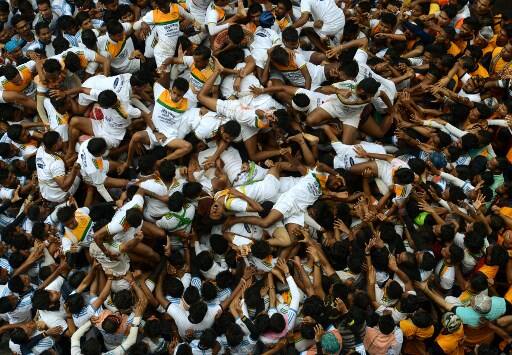  The birth of Lord Krishna was rung in with religious fervour on Tuesday and was followed by colourful 'Dahi Handi' with a distinct national flavour by thousands of Govindas all over Mumbai and other parts of Maharashtra on the occasion of Krishna Janmashtami. (Photos: AFP)