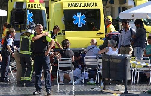 Injured people are treated in Barcelona, Spain, Thursday, Aug. 17, 2017 after a white van jumped the sidewalk in the historic Las Ramblas district, crashing into a summer crowd of residents and tourists and injuring several people, police said. (AP Photo/Oriol Duran)