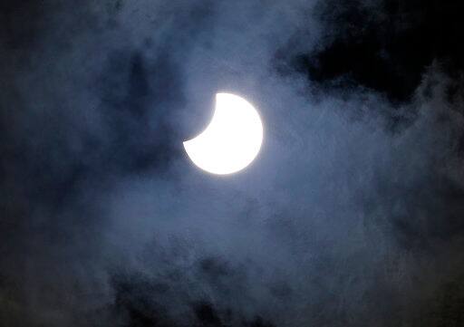 Clouds move in front of a solar eclipse in Mexico City, Monday, Aug. 21, 2017. (AP Photo/Marco Ugarte)