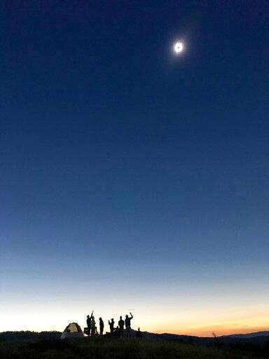 Campers from Steamboat Springs, Colo. observe the solar eclipse Tuesday, Aug. 21, 2017, at Shadow Mountain just east of Grand Teton National Park. (Erika Dahlby/Jackson Hole News&Guide via AP)