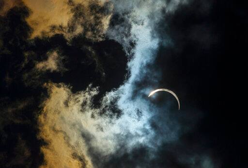 Clouds roll passed the sun at 2:42 p.m., two minutes past the peak of the solar eclipse in Graham, N.C., on Monday, Aug. 21, 2017. (Steven Mantilla/The Times-News via AP)