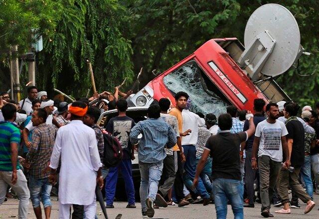 Dera Sacha Sauda chief Ram Rahim verdict: At least three OB vans of private television channels were damaged. Two vans were overturned by a mob. (AP Photo)
