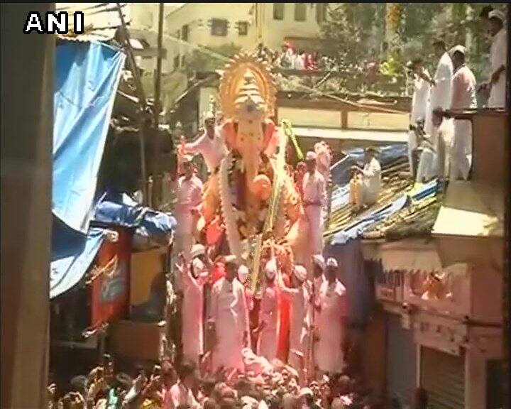 Cranes, watchtowers, drones, CCTVs and floodlights have been arranged to keep a watch on every movement of the revellers and devotees, a police official earlier said. INFO/PTI (Idol immersion procession of #LalbaugChaRaja. PIC/ANI.)