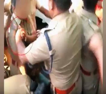 New Delhi: A rather shocking video clip has emerged in which a policeman seems to be molesting his junior, female cop while controlling the crowd.  The woman trapped in a sea of people, with male cop facing her, constantly touching her upper body party.  (All images: Screen grab/YouTube-The News Minute)