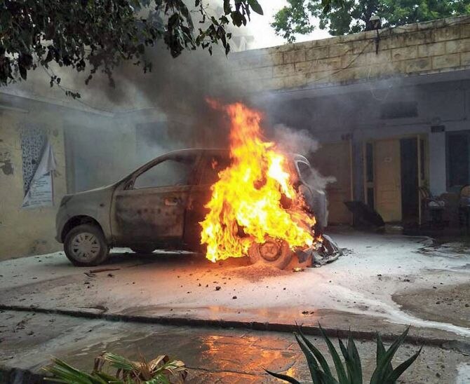     The photographs show several persons indulging in acts of violence in Panchkula on August 25 following conviction of Dera chief Gurmeet Ram Rahim Singh in a rape case.   	In the photos, protestors are seen damaging vehicles including media OB vans, throwing stones and setting vehicles on fire. (Image: File)