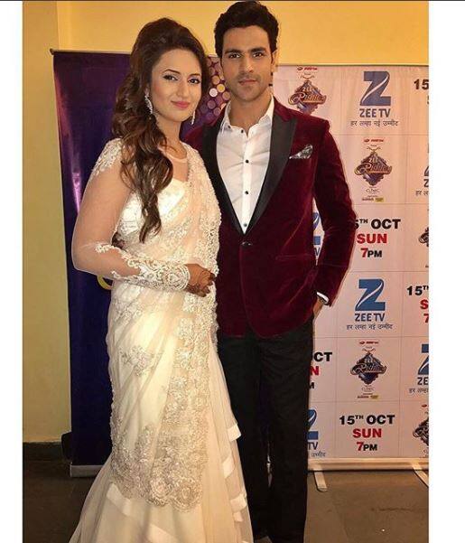 Divyanka Tripathi aka ‘Ishita’ of popular daily soap ‘Yeh Hai Mohabbatein’ flaunts her dazzling white net saree while her husband was roped in a maroon blazer and white shirt. (Image Courtesy- Instagram)
