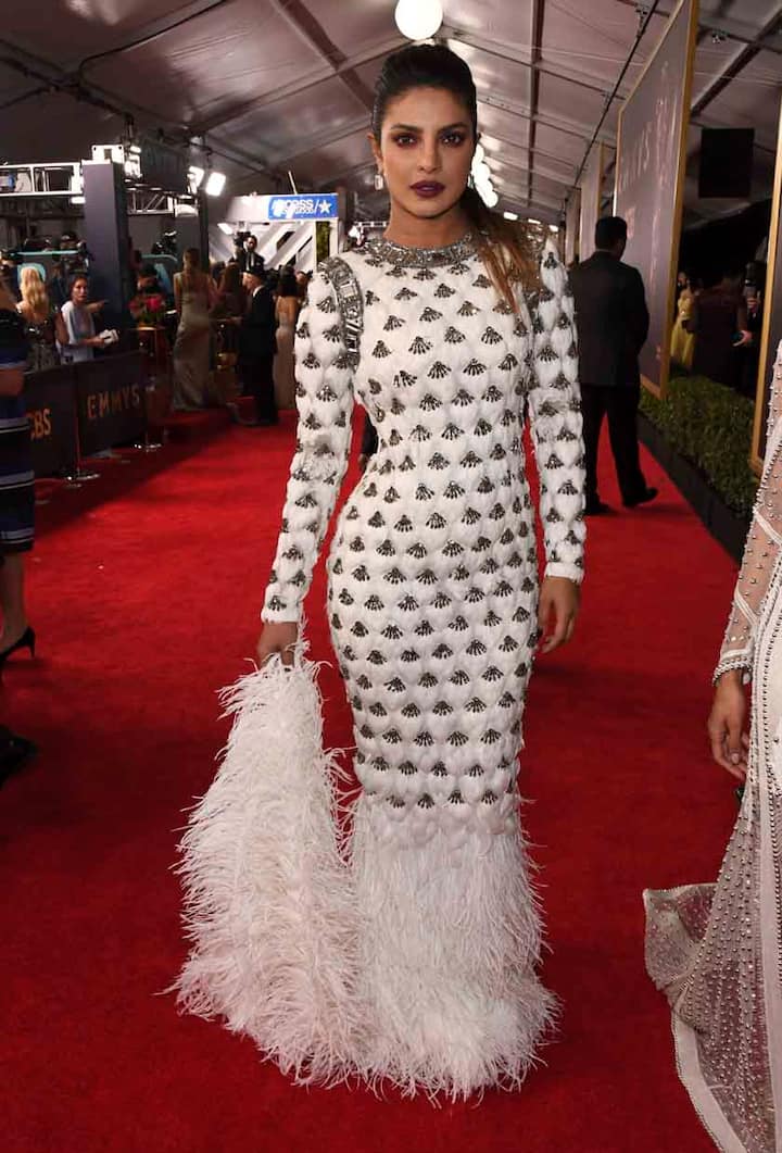 At the red carpet, Priyanka made heads turn with her full-sleeves ensemble, which was adorned with crystals and had a feather skirt train.