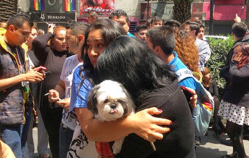 Women embrace in the street after an earthquake in Mexico City, Tuesday, Sept. 19, 2017. A powerful earthquake has jolted Mexico, causing buildings to sway sickeningly in the capital on the anniversary of a 1985 quake that did major damage. (AP Photo/Eduardo Verdugo)