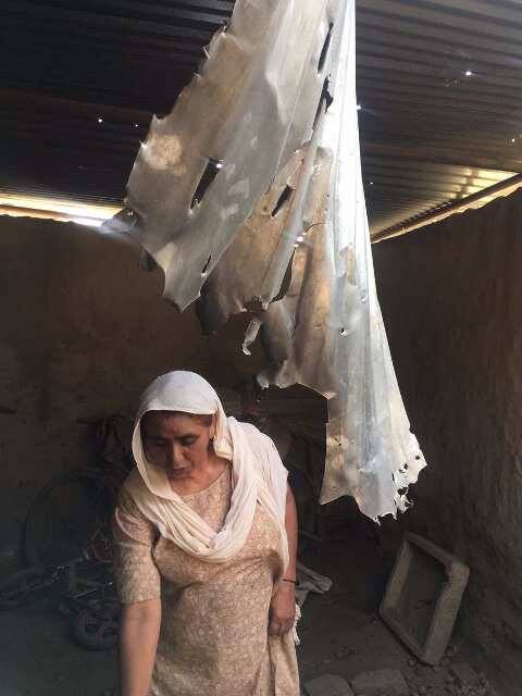Woman residing in Arnea cries over her damaged house after Pakistan Amy's mortar shelling. / ABP News image