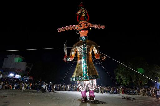 An effigy of demon king Ravana stands before it is lit up during Dussehra festival in Ahmadabad, India, Saturday, Sept. 30, 2017. Effigies of Ravana are burnt on the last day of Dussehra, commemorating the victory of good over evil. (AP Photo/Ajit Solanki)