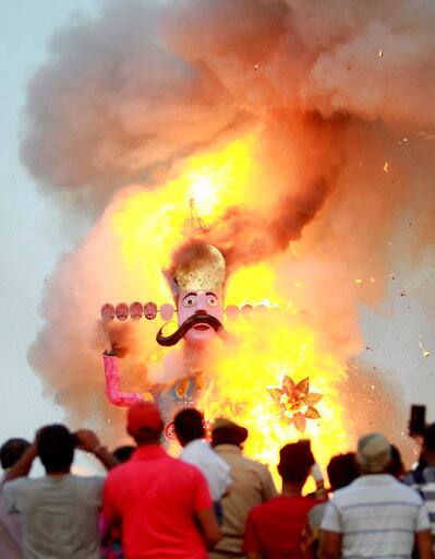 An effigy of demon king Ravana goes up in flames marking the end of Dussehra festival in Jammu, India, Saturday, Sept. 30, 2017. Dussehra commemorates the triumph of Lord Rama over the demon king Ravana, marking the victory of good over evil. (AP Photo/Channi Anand)