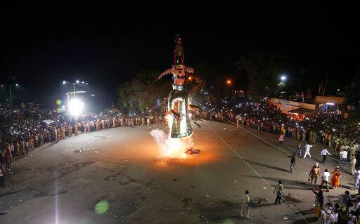 An effigy of demon king Ravana goes up in flames during Dussehra festival in Ahmadabad, India, Saturday, Sept. 30, 2017. Effigies of Ravana are burnt on the last day of Dussehra, commemorating the victory of good over evil. (AP Photo/Ajit Solanki)