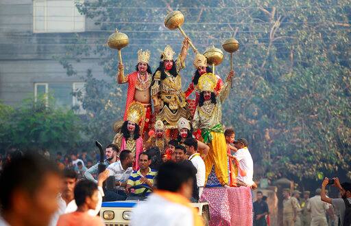 Artists dressed up as Hindu gods shout religious slogans during Dussehra festivities in Jammu, India, Saturday, Sept. 30, 2017. Dussehra commemorates the triumph of Lord Rama over the demon king Ravana, marking the victory of good over evil. (AP Photo/Channi Anand)