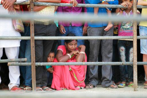 Indians watch a Dussehra festival procession in Jammu, India, Saturday, Sept. 30, 2017. Dussehra commemorates the triumph of Lord Rama over the demon king Ravana, marking the victory of good over evil. (AP Photo/Channi Anand)