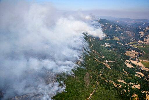 More than 100 people were being treated hospitals for fire-related injuries or health issues including burns, smoke inhalation and shortness of breath. / AP IMAGE