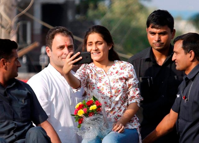 Girl climbs Rahul Gandhi’s van to click selfie with him in Gujarat Watch: Girl climbs Rahul Gandhi's van to click selfie with him in Gujarat