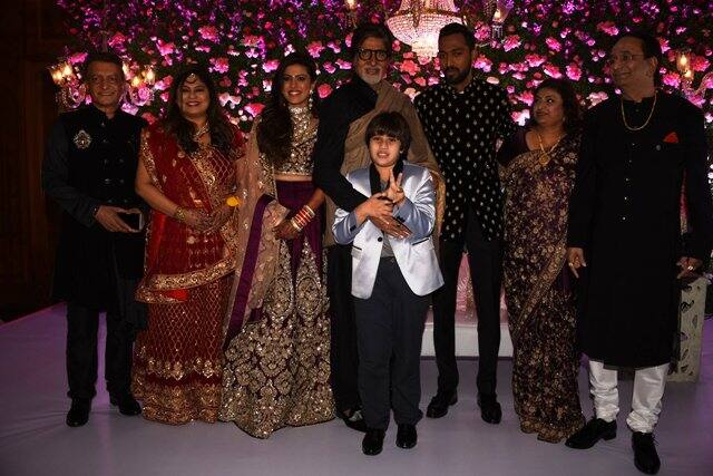 Big B poses for a photograph with the newly-wed couple.