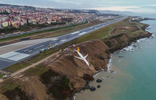 Watch video Turkish plane dangles on a cliff Watch: Dramatic visuals of a Turkish plane skidding off runway and getting stuck on a cliff edge