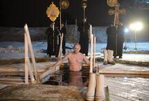 Shirtless Vladimir Putin takes a dip in freezing Russian lake to celebrate Epiphany. See pictures