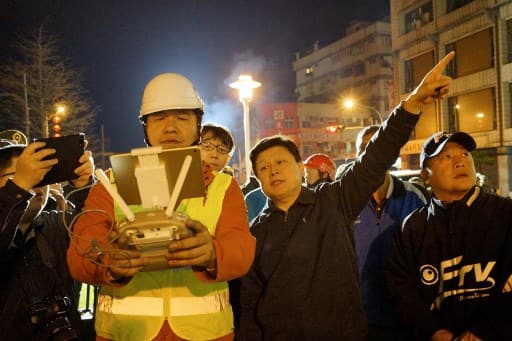 Rescue workers check the quake site in Hualien after a strong 6.4-magnitude quake rocked eastern Taiwan early on February 7, 2018. The 6.4-magnitude earthquake on the east coast of Taiwan has left two dead and more than 200 injured, the government said on February 7, after buildings crumbled and trapped people inside. / AFP PHOTO / Paul YANG