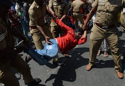 Police detain a member of the Revolutionary Students Youth Federation (RSYF). PIC/AFP.