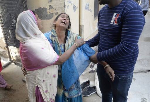 Indian resident Gyan Kaur (C) reacts to the confirmation of the death of her husband Balwant Rai in Khan Ke village some 20kms from Jalandhar on March 20, 2018. The bodies of 39 Indian construction workers kidnapped in Iraq in 2014 by the Islamic State group have been found in a mass grave, India's foreign minister said March 20. Sushma Swaraj told the upper house of parliament the workers had been murdered by IS. Their bodies had been found in the grave in the village of Badush northwest of the city of Mosul and taken to a local organisation for DNA testing. / AFP PHOTO / SHAMMI MEHRA