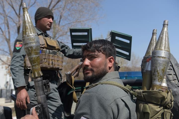 Policemen patrolling the area post the explosion. The victims largely include teenage people, who were students at the Kabul University. Image: / AFP PHOTO / SHAH MARAI