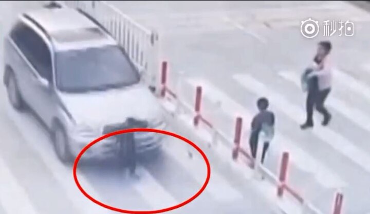 Bizarre ! Child gets hit by car while crossing street, mother remains busy on phone  Bizarre ! Child gets hit by car while crossing street, mother remains busy on phone