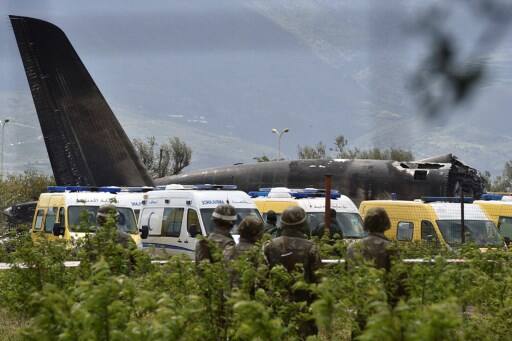 Rescuers and security forces are seen around the wreckage of the plane. / Image: AFP PHOTO / RYAD KRAMDI
