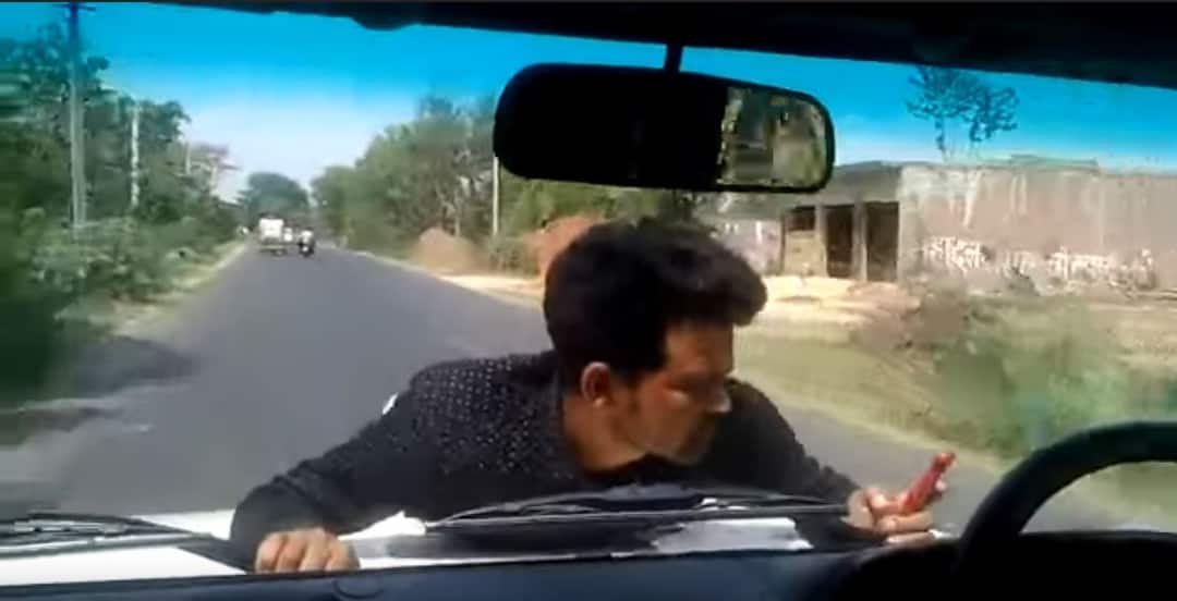 Watch Video: Man clings to UP official’s car bonnet for 4 km Watch Video: Man clings to UP official’s car bonnet for 4 km Watch Video: Man clings to UP official’s car bonnet for 4 km