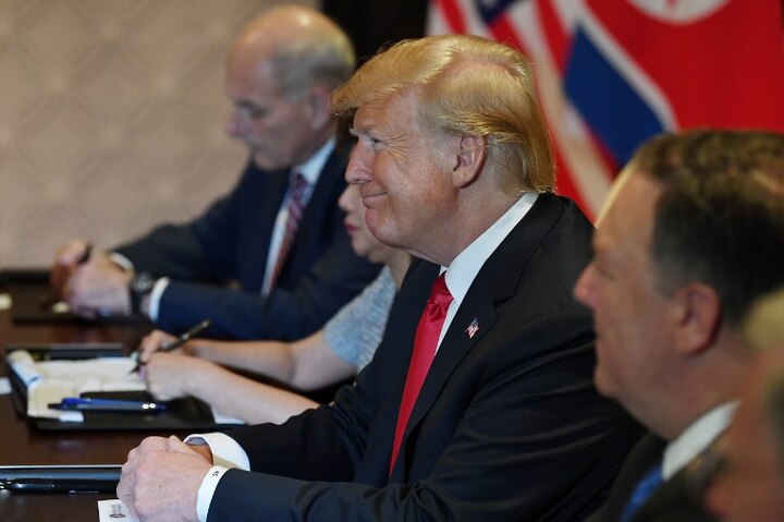 US President Donald Trump looks on while seated with members of his delegation during the US-North Korea summit with North Korea's leader Kim Jong Un  / AFP Photo