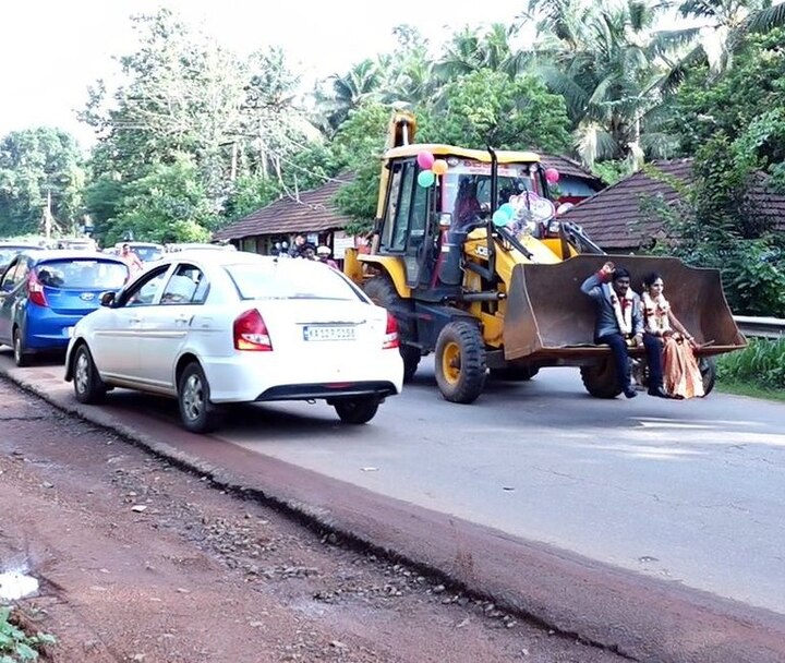 Newly married couple gets home riding JCB vehicle in Karnataka Newly married couple gets home riding JCB vehicle in Karnataka