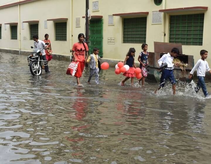 Children can be seen walking in ankle-deep water. Flights to Delhi were cancelled because of inundated runway in airports. 