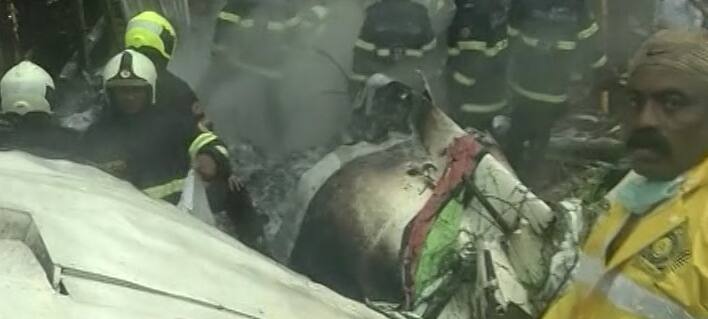 Rescue workers present at the site of the crash, working to clear the debris 