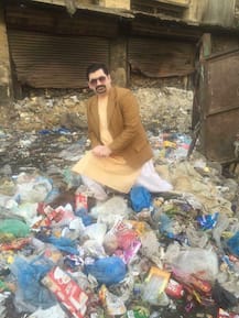 PICTURES: Pakistani politician goes all out for votes; poses in gutter, drinks sewage water