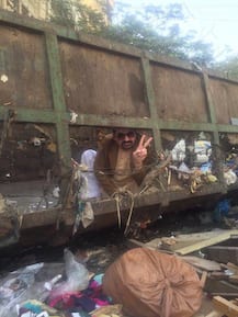 PICTURES: Pakistani politician goes all out for votes; poses in gutter, drinks sewage water