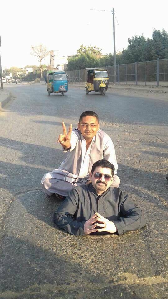 Politician poses inside a gutter for his voters