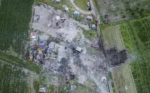 Images taken from a distance of the first blast showed a tall plume of white smoke billowing into the sky. Image: Aerial view of the site./AFP Photo/ Pedro Pardo