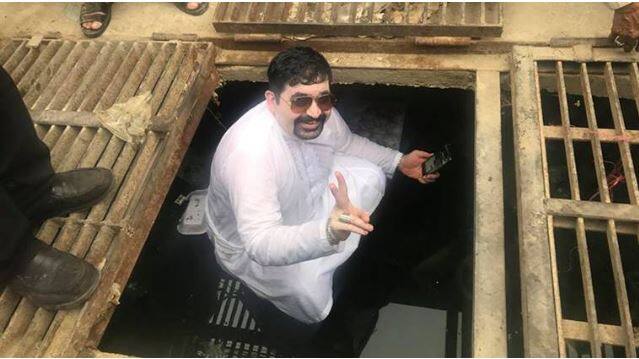 Ayaz Motiwala is seen in a fresh white attire and showing victory sign from inside a gutter. Image: Facebook
