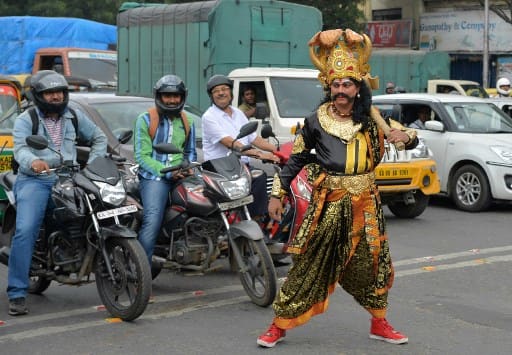 The Halasuru Gate traffic police roped in 'Yamaraja' as their brand ambassador to drive home the message of the dangers of not sporting a helmet, reckless driving and other violations. / AFP PHOTO / MANJUNATH KIRAN