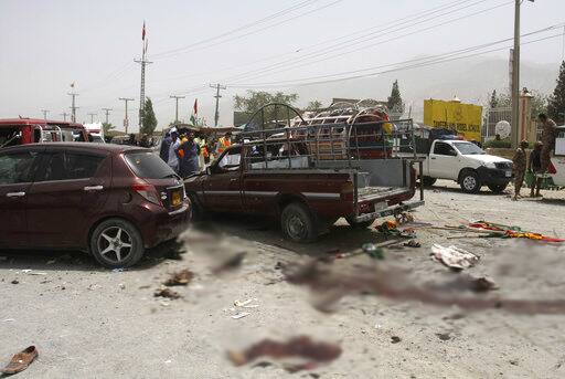 Pakistani volunteers and security officers visit the site of a bombing in Quetta, Pakistan, Wednesday, July 25, 2018. (AP Photo/Arshad Butt)