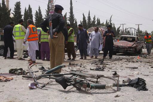 Pakistani security personnel visit the site of bombing in Quetta, Pakistan, Wednesday, July 25, 2018. (AP Photo/Arshad Butt)