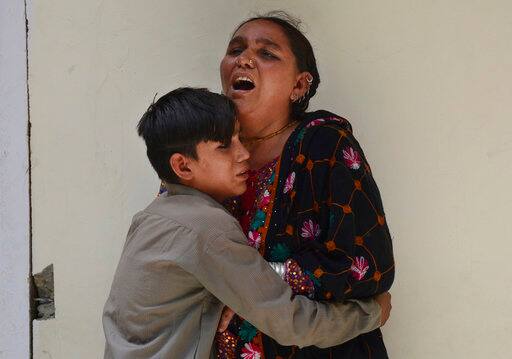 A Pakistani woman mourns the death of her family member outside a hospital in Quetta, Pakistan, Wednesday, July 25, 2018. (AP Photo/Arshad Butt)