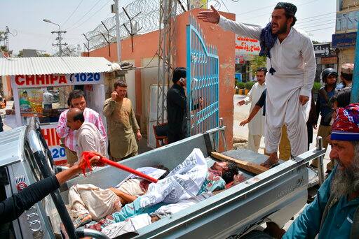 Volunteers rush injured persons to a hospital in Quetta, Pakistan, Wednesday, July 25, 2018. (AP Photo/Arshad Butt)