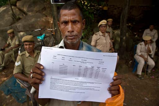 Muhammed Mainuddin, shows his name on a sheet collected from the National Register of Citizens draft center in Mayoung, about 55 kilometers (34 miles) east of Gauhati, India, Monday, July 30, 2018. PIC/AP.